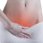 Close up of a woman's abdomen with menstrual pain isolated on white background